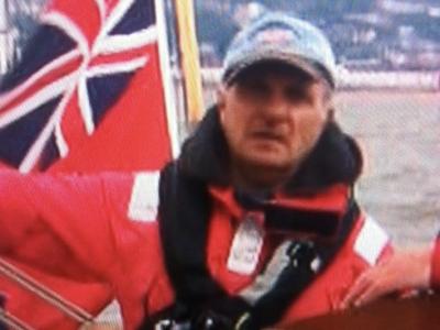 David White in the cockpit of a cruising yacht